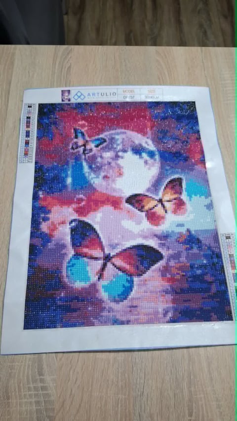 Diamond painting pattern showing colorful butterflies and full moon against pink and blue cosmic background