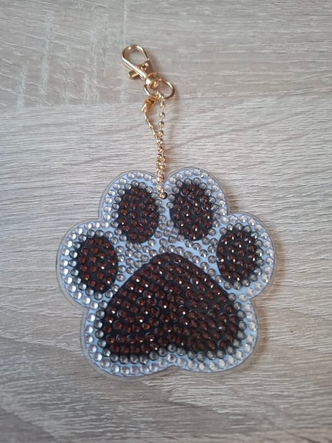Beaded paw print keychain with brown and clear rhinestones on a gold chain with clasp