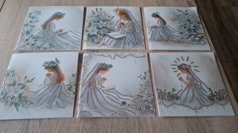 Six decorative tiles with embroidered designs of women in flowing dresses surrounded by floral and nature motifs arranged in a 2x3 grid.