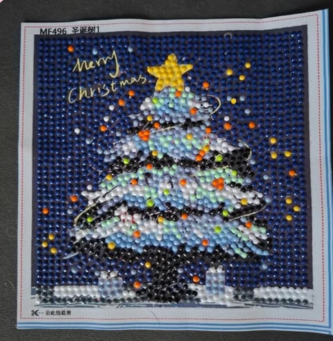 Beaded Christmas card with embellished Christmas tree, colorful ornaments, gold star, and Merry Christmas text on dark blue background