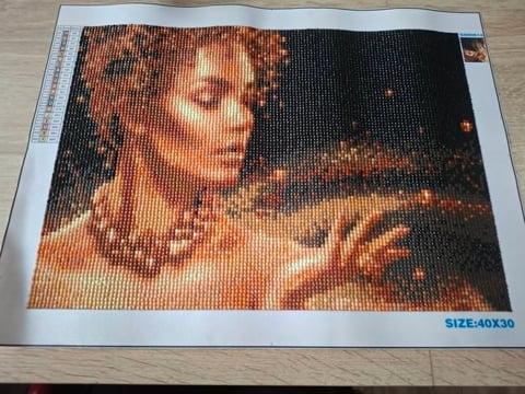 Pixel art portrait of a woman with warm skin tones against dark background, 40x30 size printed on paper