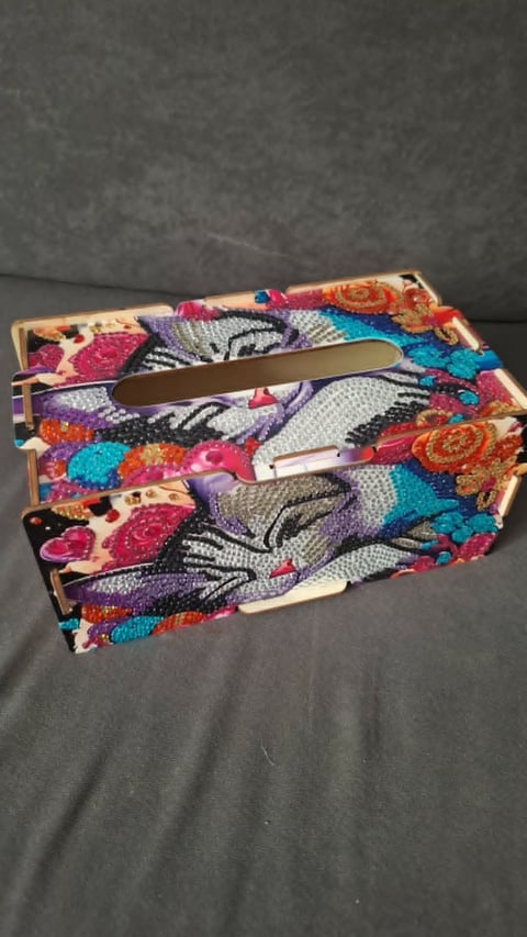 Colorful patterned tissue box holder with decorative fabric featuring flowers and animals in vibrant pink, blue, and purple tones