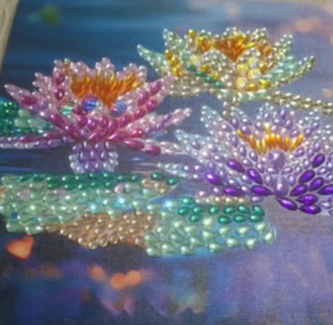 Colorful digital flowers with pearl-like beads in vibrant pinks, purples, yellows, and greens against a soft blue gradient background